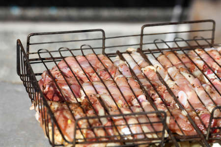 Marinated chicken kebab with  onions on grill.の写真素材