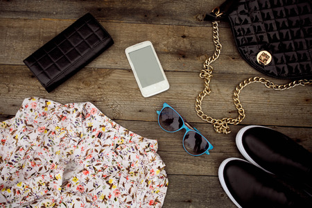 Still life of fashion woman. Woman clothes and accessories on wooden backgroundの写真素材