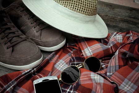 Set of clothes and various accessories for men on old wooden tableの写真素材