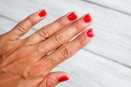 The hand demanding manicure, nails with a bare varnishの写真素材