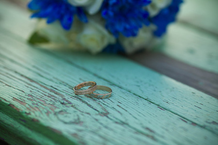 Wedding rings on a wooden backgroundの写真素材