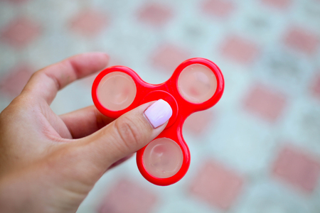 The female hand holds spinnersの写真素材