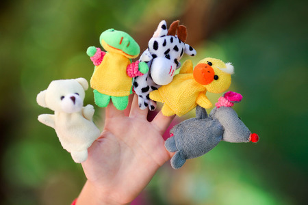 Animal dolls child playing on fingers.の写真素材