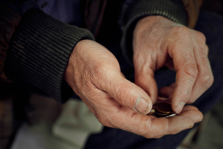 Old hands count pennies. The concept of poverty, wage arrears.Concept Sanction poverty in Russia.の写真素材