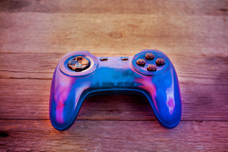 The joystick of a blue background for a game on a wooden background