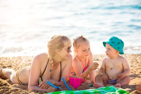 Happy mother resting on the sea with her daughterの写真素材