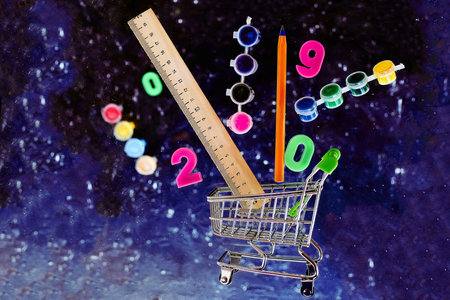 School supplies in the shopping cart on space background. levitation. copyspace.