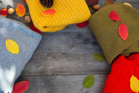 In a circle spread things and autumn leaves on a wooden background. Top view, copy space.