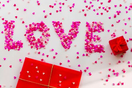 Red letter, pink love hearts text and red gift box.の写真素材