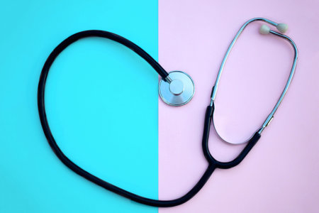Heart shaped stethoscope, on a pink and blue background. Copy space.の写真素材