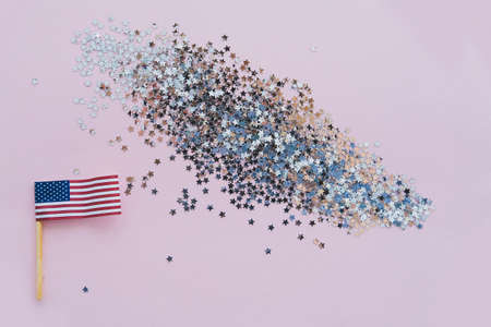 America flag and sparkles on pink background, flat lay. A holiday in America. 4th of July, America's Happy Independence Day. Labor day. Copy space for text.の写真素材
