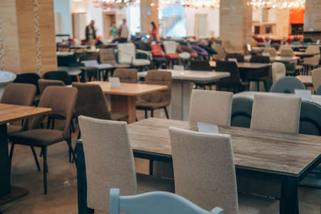 The motion is blurry. Purchase a variety of tables and chairs from different materials at a furniture store. A variety of furniture in shapes, sizes, styles.の写真素材