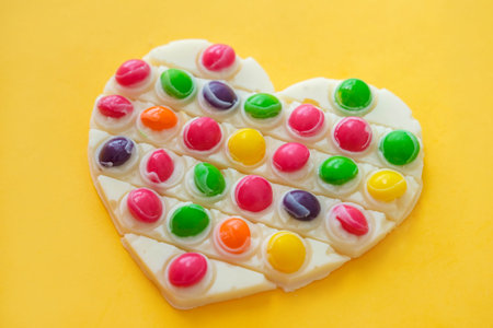 Use the popular pop it toy as a chocolate mold. White chocolate and colorful candies and popit silicone toy. DIY concept. Step-by-step photo instructions. Step 11.の写真素材