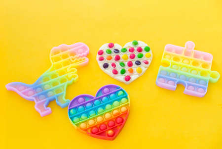 Use the popular pop it toy as a chocolate mold. White chocolate and colorful candies and popit silicone toy. DIY concept. Step-by-step photo instructions. Step 11.の写真素材