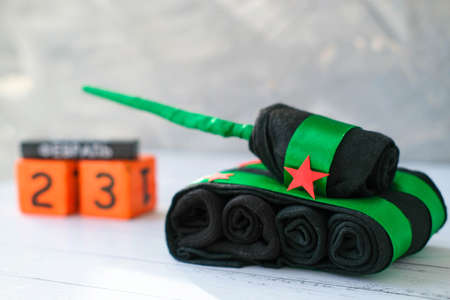 Tank of socks and wooden calendar with Russian text February 23 on gray background. Gift Ideas for Father, Husband, Brother, Grandfather by February 23, Handmade. DIY concept.の写真素材
