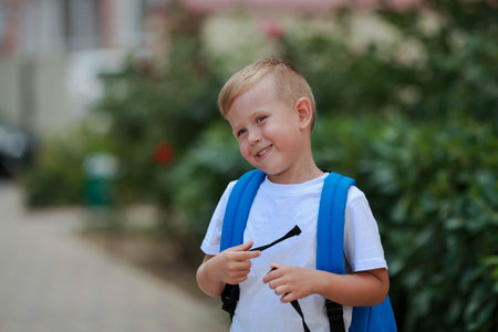 Portrait of a boy with a briefcase on the street. back to school.の写真素材