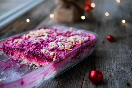 Homemade New Year is a herring salad under a fur coat on a wooden background. Russian Christmas traditional cuisine.の写真素材