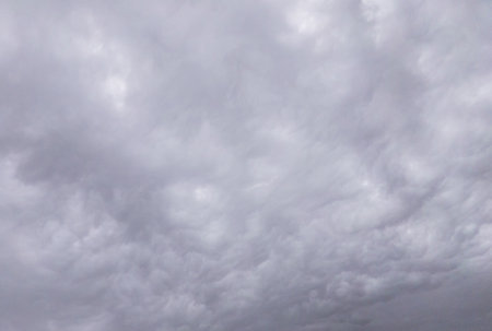 A dramatic sky with clouds bad weather heaven cyclone warning.の写真素材