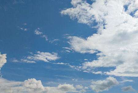 A fluffy blue sky with clouds natural weather skyline.の写真素材