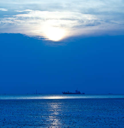 Blue sea with ocean liner at sunsetの写真素材