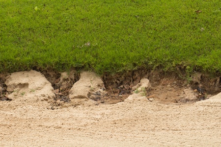 Golf sand trap on the green grassの写真素材