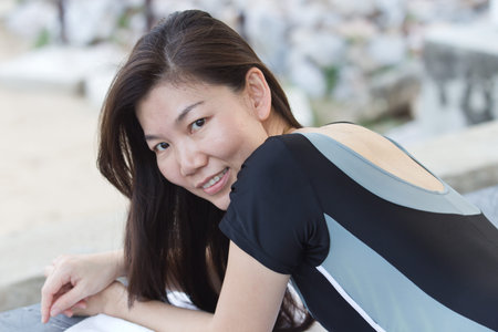 Thoughtful woman lying on the floor and smiling