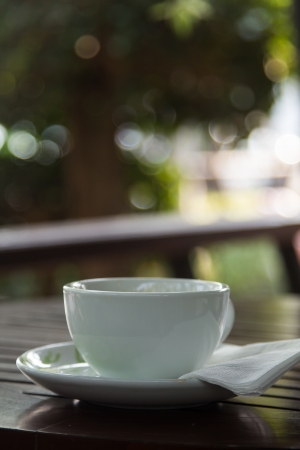 White cup of coffee in a coffee shopの写真素材