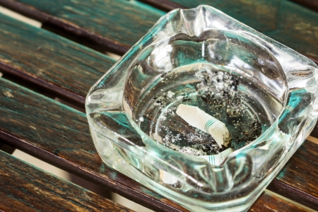 Closeup view of full ashtray on the table.の写真素材