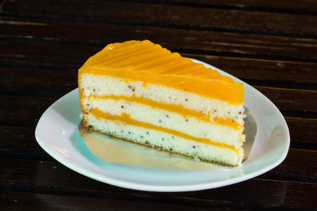 Delicious orange cake on a white dish.