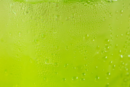 Water drops on a green plastic cup.の写真素材