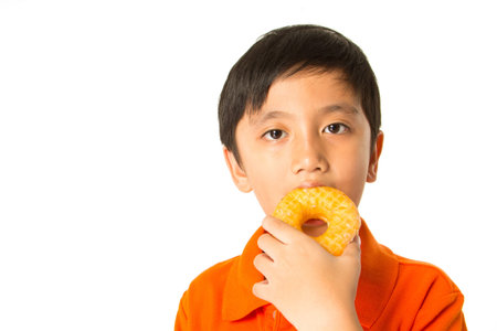 Handsome boy eating a donut.