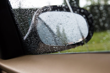 Rain on a car mirror and windowの写真素材