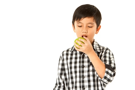 Kid with green apple isolated on white backgroundの写真素材
