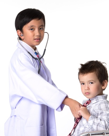 Two boys playing a doctor with a patient.の写真素材