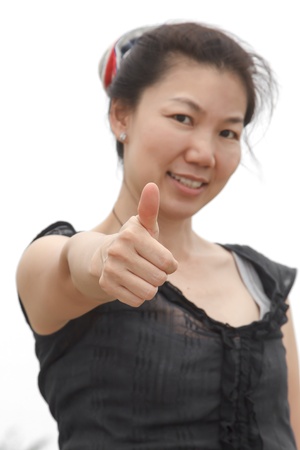 Young pretty Asian woman showing thumb isolated on white background.の写真素材