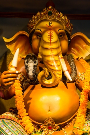 ganesh statue in sitting action with many decorationのeditorial素材