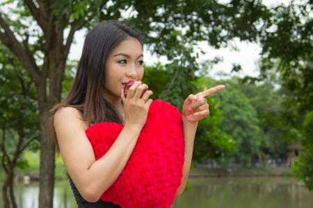 Cheerful young woman eating an appleの写真素材