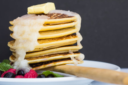 Pancakes with berries on a white plate.