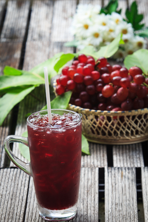 Grape juice and ice on the groundの写真素材