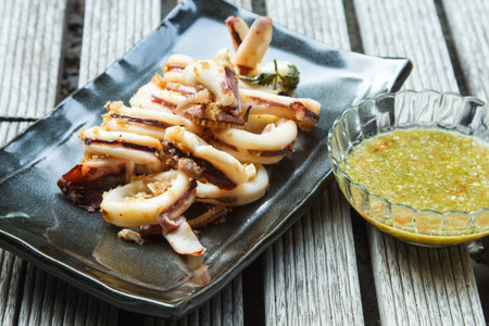 barbecue grilled squid and sliced on black plate
