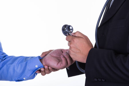 examination of the pulse at the wrist by a doctor.の写真素材