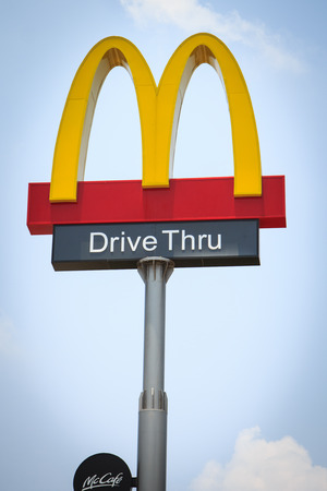 BANGKOK, THAILAND - APRIL 10: AN emblem of McDonalds on blue sky, shot in front of McDonalds restaurant at Bangkok, Thailand on April 10 2014. McDonald's Corporation is the world's largest of hamburger fast food restaurants.のeditorial素材