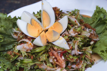 Wing bean salad, spicy shrimp, served with boiled egg.の写真素材