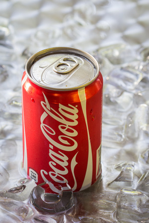 BANGKOK, THAILAND - MAY 8, 2014 : Can of Coca-Cola lying on ice. Coca-Cola is the one of the worlds favourite soft drinks.のeditorial素材