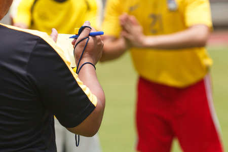 Referee soccer recorded player foul in the gameの写真素材