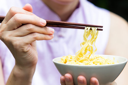 Beautiful young women are eating asian noodle
