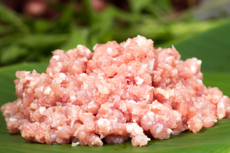 minced pork placed on banana leaves in kichenの写真素材