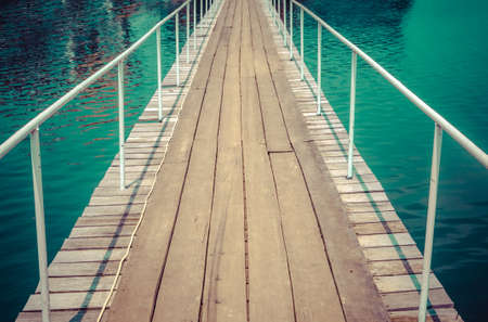 Wooden bridge over the river foe r thailandの写真素材