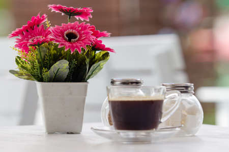 black coffee with cube sugar and ice coffee on tableの写真素材