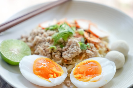 Chinese Style red pork noodle with boiled eggsの写真素材